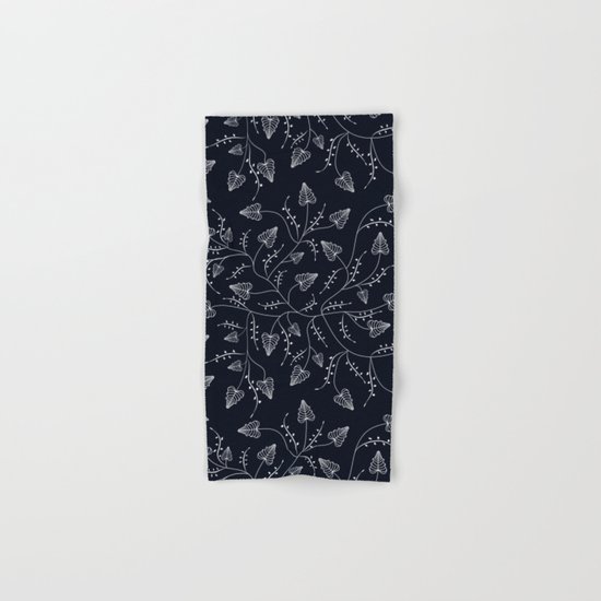 Delicate leaves on a black background . Hand & Bath Towel