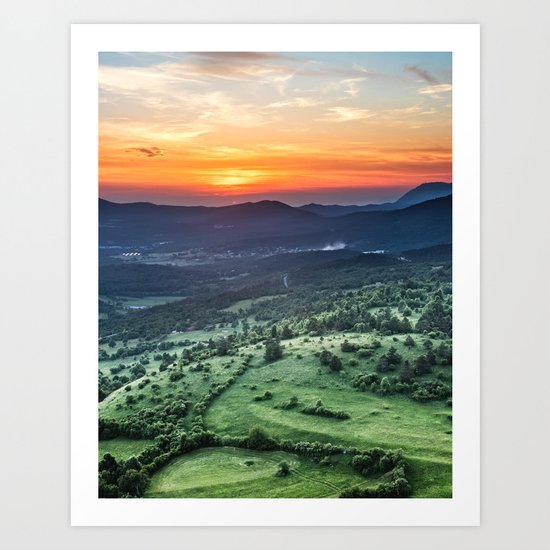 Beautiful sunset behind green fields Art Print