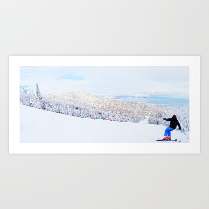 Skier at a ski resort with snowy mountain and lake Art Print