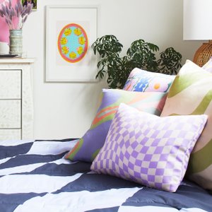 bed with bright and pastel colored checkered bedding and pillows
