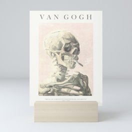 Vincent Van Gogh - Skull of a skeleton with burning cigarette (version with text & rosy background) Mini Art Print