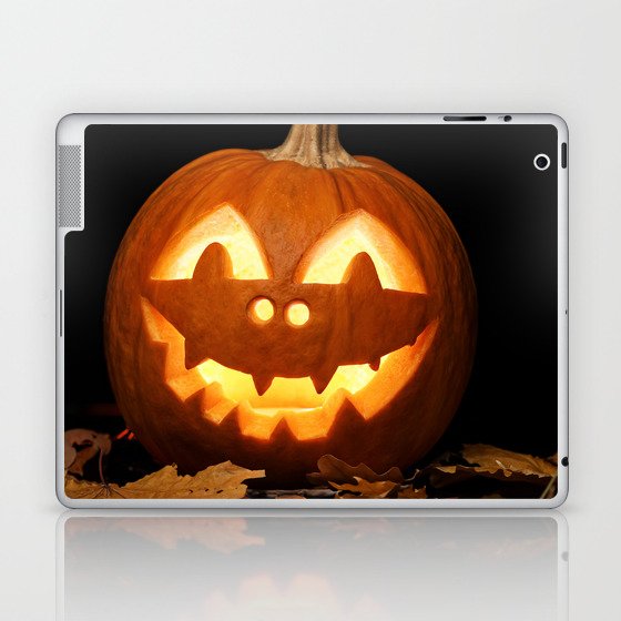 Carved Pumpkin for Halloween and Autumn Leaves on Black Background Laptop & iPad Skin