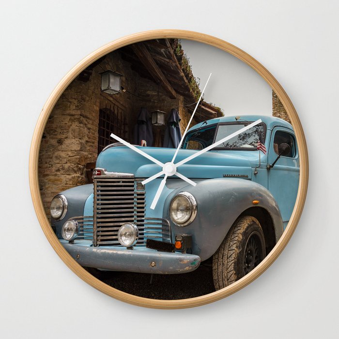Historic blue-colored pickup parked in the streets of an historic Italian village Wall Clock