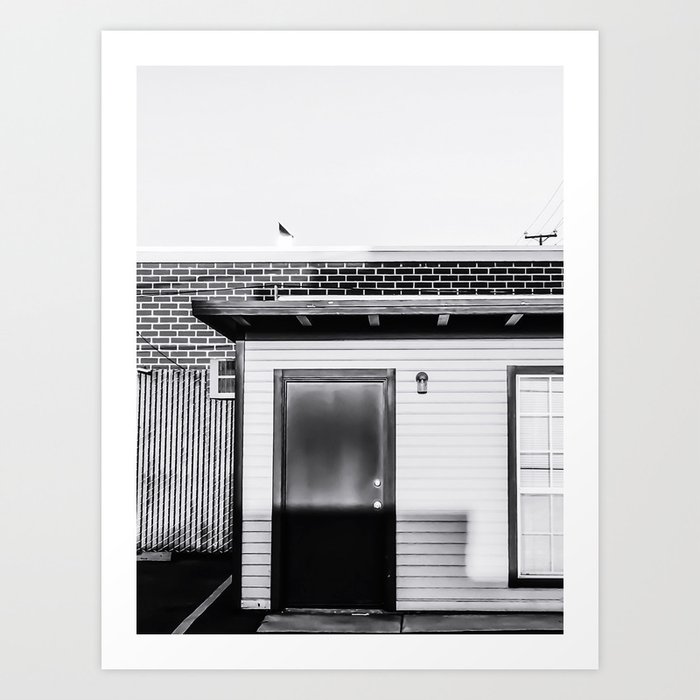 wood building with brick building background in black and white Art Print