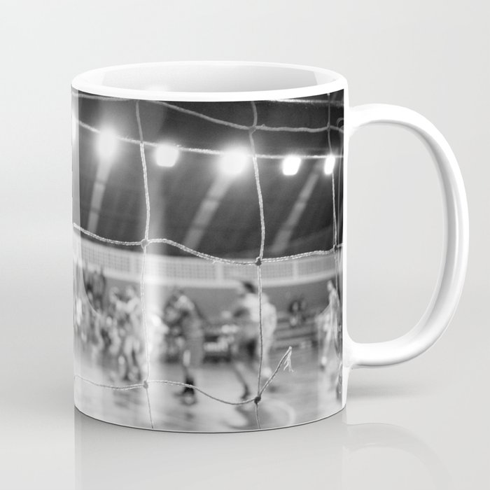 Black and White Photo of a handball game from behind the net Coffee Mug