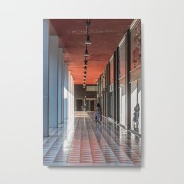 A woman from behind pushes a stroller under the arcades of the city Metal Print