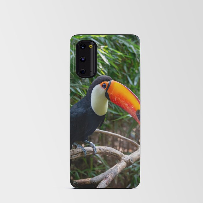 A toucan laid on a tree branch in the forest Android Card Case