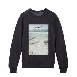 A picture with a boat and a dreamy view of the sea Kids Crewneck