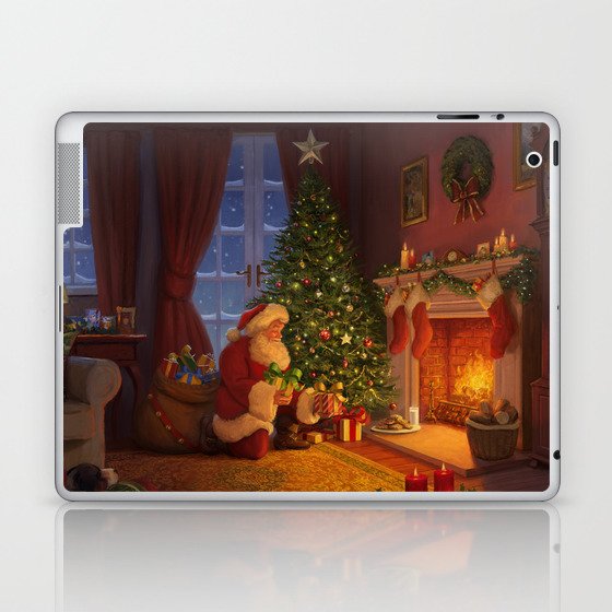 Santa putting presents by the tree Laptop & iPad Skin
