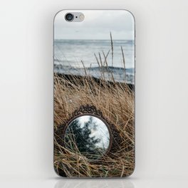 Vintage mirror on seaside reflects forest and sky. iPhone Skin