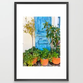 Blue door with plants Framed Art Print