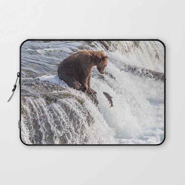 Young grizzly bear sits at waterfall Laptop Sleeve