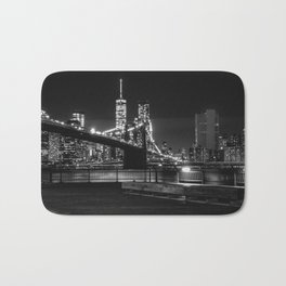 Brooklyn Bridge and Manhattan skyline at night in New York City black and white Bath Mat