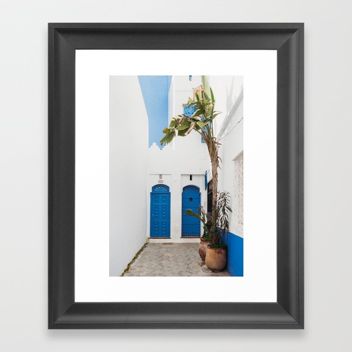White and blue moroccan street and doors with banana tree Framed Art Print