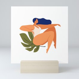 Beautiful woman sitting on monstera leaf Mini Art Print