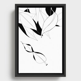 Black and white leaves with one falling Framed Canvas