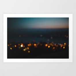 Night-time bokeh blurred out of focus city lights at sunset Art Print