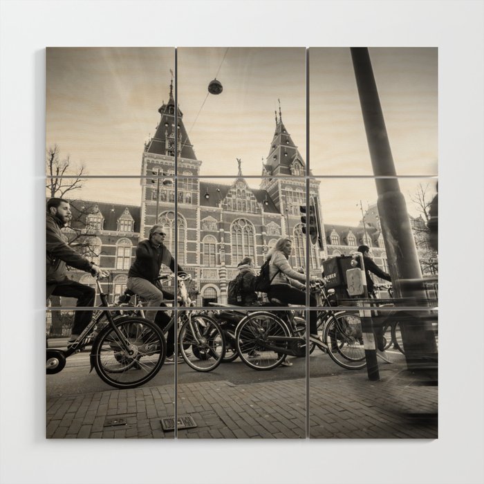 Cyclists ride in Amsterdam street in front of the Rijksmuseum Wood Wall Art