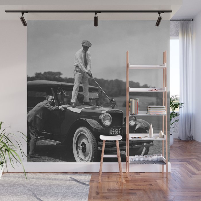 Pro golfer hitting golf ball off vintage car hood ornament on a dare par one 18th hole funny black and white golf sport photograph - photography - photographs Wall Mural
