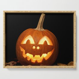 Carved Pumpkin for Halloween and Autumn Leaves on Black Background Serving Tray