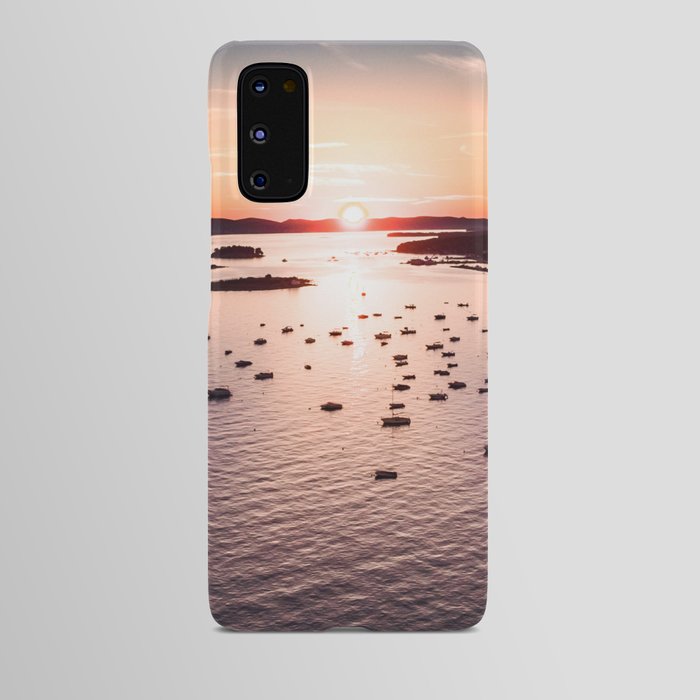Dramatic sunset on the sea coast with boats in the sea Android Case