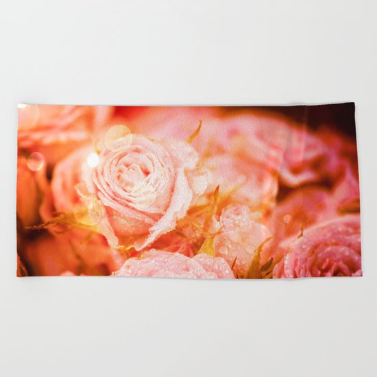 Roses with waterdroplets and bokeh Beach Towel
