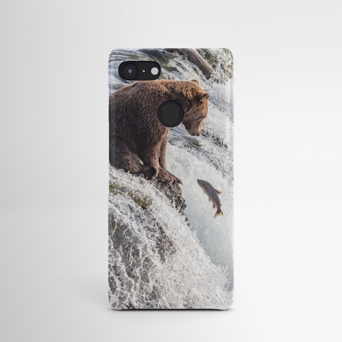 Young grizzly bear sits at waterfall Android Case