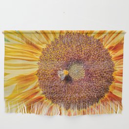 Close up view of a Sunflower bloom with a bee collecting pollen Wall Hanging