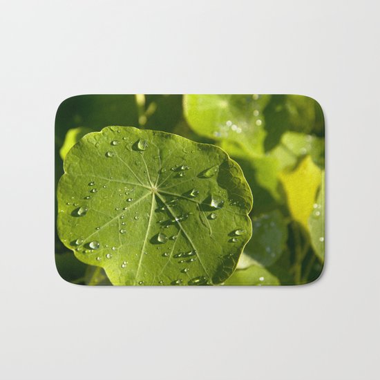 Rain drips on a nasturtium leaf Bath Mat