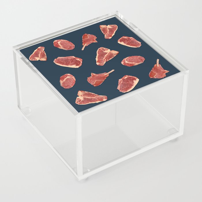 Pattern of fresh beef steaks over blue Acrylic Box