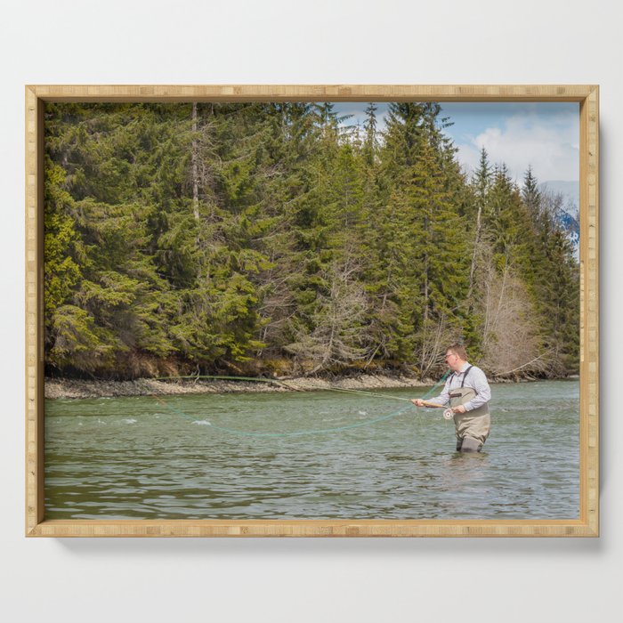 Close up of a fisherman spey casting on a river in British Columbia, Canada, in the spring Serving Tray