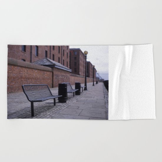 a row of benches Beach Towel