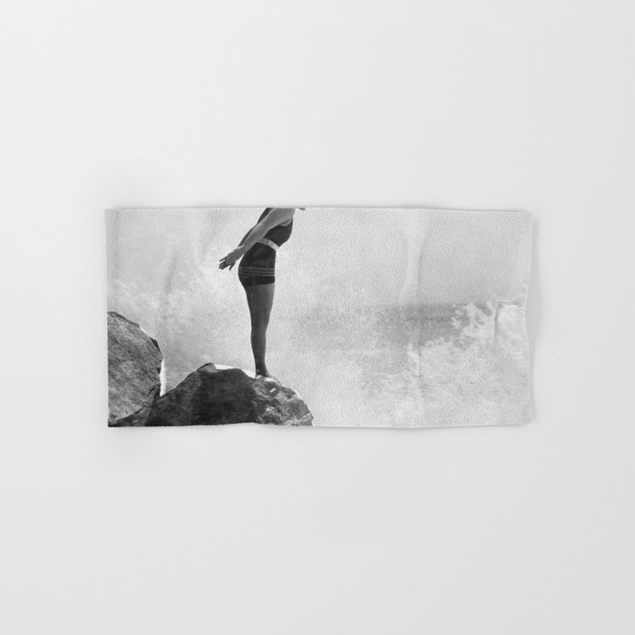 Female swimmer on rock above crashing surf Hand & Bath Towel