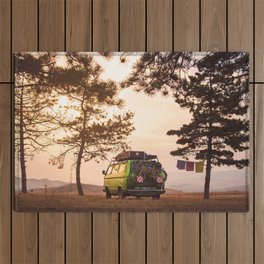 Vintage camper van parked on the top of the hill in the beautiful sunset sky Outdoor Rug