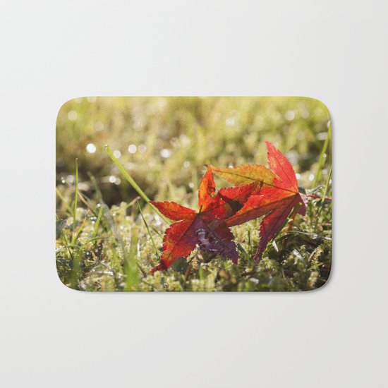 Indian Summer II Red marple leaves in wet grass at backlight Bath Mat