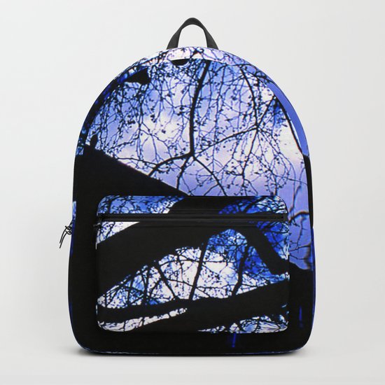 Urban maple tree in a winter evening with a city building and a cloudy sky Backpack