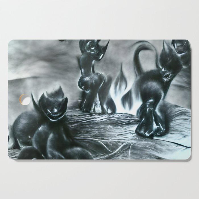 Black kittens playing in hell Cutting Board