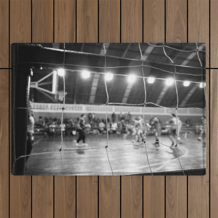 Black and White Photo of a handball game from behind the net Outdoor Rug