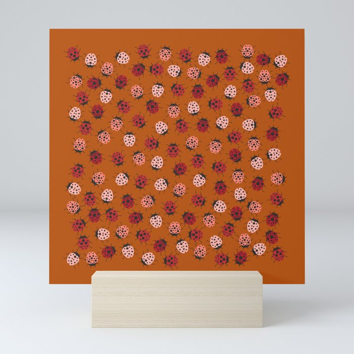 All over Modern Ladybug on burnt orange Background Mini Art Print