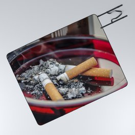 A ruby-colored glass ashtray contained three used cigarette butts along with their ashes A healthcar Picnic Blanket