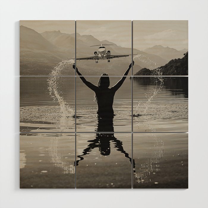 On the wings of love; airplane landing over lake guide by female swimming alpine mountain black and white photograph - photographs - photography Wood Wall Art