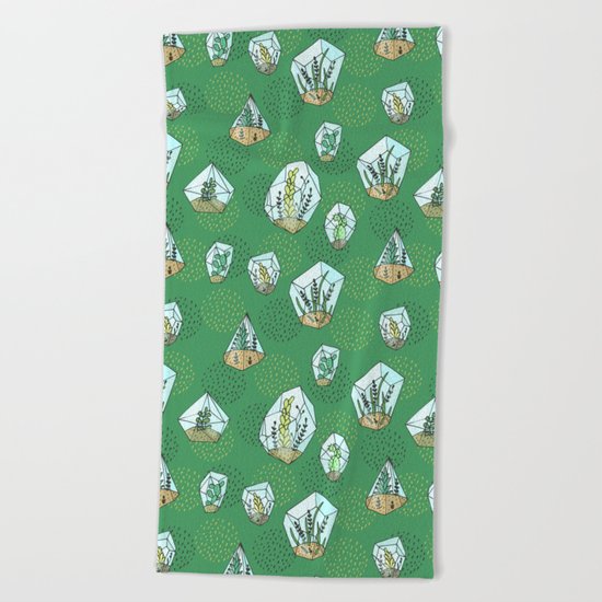 Green succulents in the glass vase Beach Towel