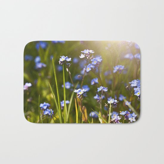 Forget me not flowers in sunlight Bath Mat