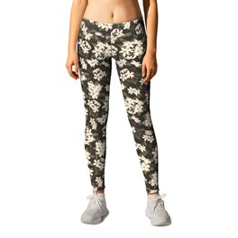 Cream and yellow flowers over brown background Leggings