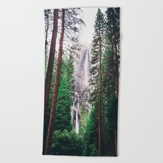 Waterfall amongst trees Beach Towel