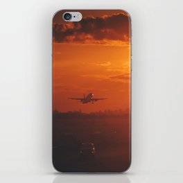 Airplane taking off from New York City airport into the sunset iPhone Skin