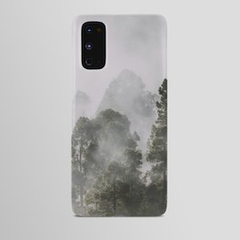 Tall forest trees above the morning mist Android Case