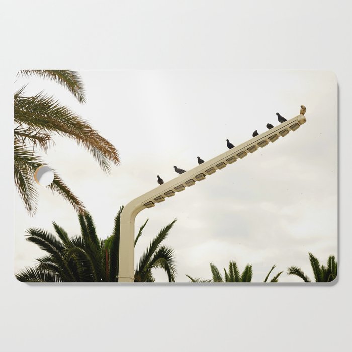 Birds perched on street lamp by the beach | Simple Travel Photography Cutting Board