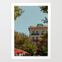 Hotel in Biarritz in front of a terrace with pink flowers in the trees. Art Print
