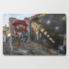Dark dystopian graffiti in Alfama, Lisbon, Portugal - urban streetart, street and travel photography Cutting Board